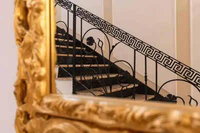 a reflection of a spiral staircase in a mirror at Decimo Meridio- At Spanish Steps- in Rome