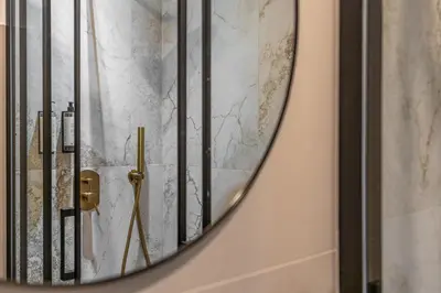 a mirror hanging on a wall with a shower at Decimo Meridio- At Spanish Steps- in Rome