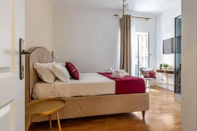 a bedroom with a bed with a table and a chair at Decimo Meridio- At Spanish Steps- in Rome