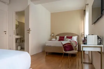 a bedroom with a bed and a chair and a table at Decimo Meridio- At Spanish Steps- in Rome