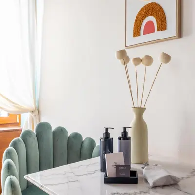 a dining room with a table and a blue chair at Suite Trevi - Charming Loft Near Trevi Fountain in Rome