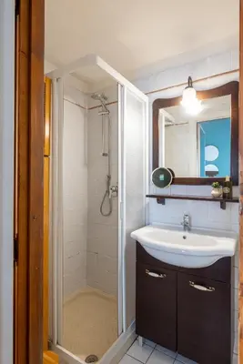 a bathroom with a sink and a shower at Suite Trevi - Charming Loft Near Trevi Fountain in Rome