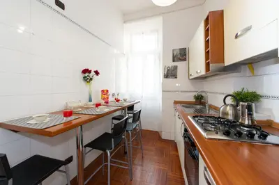 a kitchen with white walls and wooden counter tops at Holiday Home House Fornaci in Rome