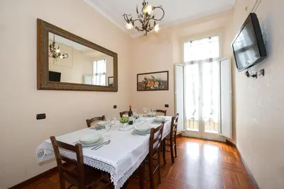 a dining room with a table with chairs and a mirror at Holiday Home House Fornaci in Rome