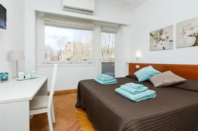 a bedroom with a bed with blue towels on it at Roma Trastevere Relais Guest House in Rome