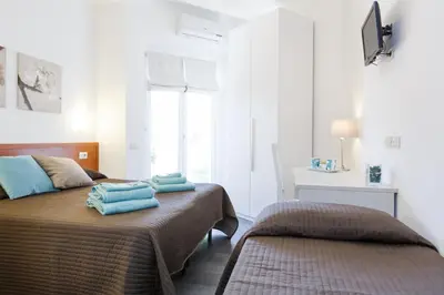 a bedroom with two beds with towels on it at Roma Trastevere Relais Guest House in Rome