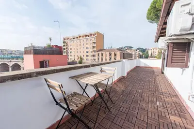 two chairs and a table on a balcony at San Peter's - Cosy Renovated Penthouse in Rome