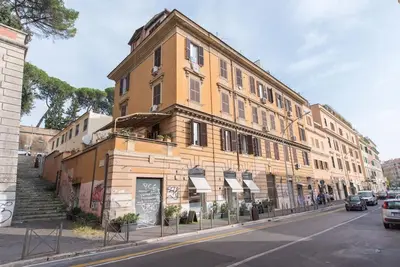 a large yellow building on the side of a street at San Peter's - Cosy Renovated Penthouse in Rome