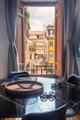 a room with a table and chairs and a window at Imperial House San Calisto 7 in Rome