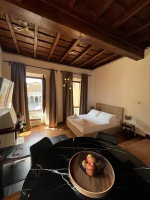 a room with a table with a bowl of fruit on it at Imperial House San Calisto 7 in Rome