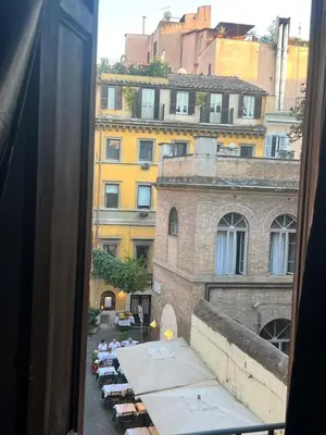 a view from a window of a courtyard with umbrellas at Imperial House San Calisto 7 in Rome