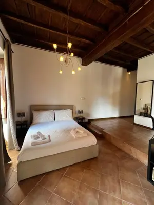 a bedroom with a bed and a chandelier at Imperial House San Calisto 7 in Rome