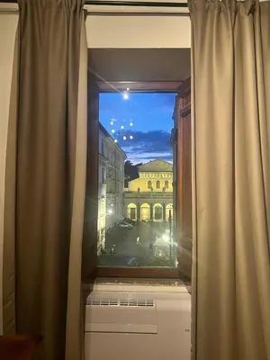 a window with a view of a building at Imperial House San Calisto 7 in Rome