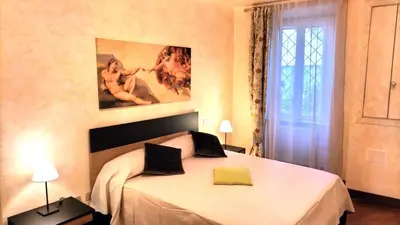 a bedroom with a large white bed in a room at Benedetta Suite Trastevere in Rome