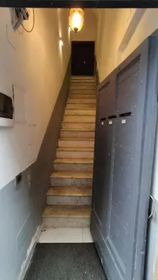 a set of stairs with two blue doors and a hallway at Benedetta Suite Trastevere in Rome