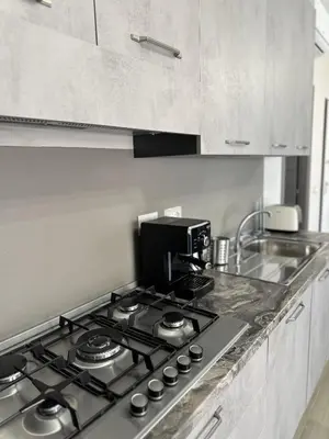 a kitchen with a stove top with a coffee maker at Casa Sofia, a 4 fermate metro dal Vaticano in Rome