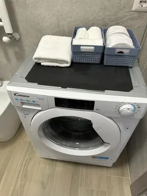 a washing machine with towels on top of it at Casa Sofia, a 4 fermate metro dal Vaticano in Rome