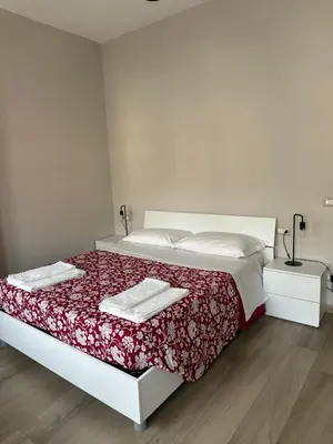 a bedroom with a bed with two towels on it at Casa Sofia, a 4 fermate metro dal Vaticano in Rome