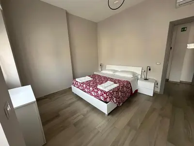 a bedroom with a bed and a wooden floor at Casa Sofia, a 4 fermate metro dal Vaticano in Rome