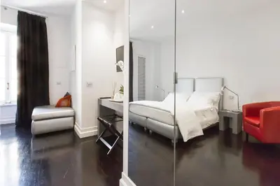 a bedroom with a bed and a desk and a chair at Xenia Guest House in Rome