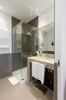 a bathroom with a sink and a shower and a mirror at Xenia Guest House in Rome