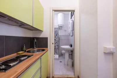 a small kitchen with a sink and a toilet at Charming suite with view in the heart of Rome in Rome