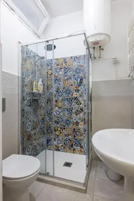 a bathroom with a shower with a toilet and a sink at Charming suite with view in the heart of Rome in Rome