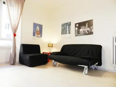 a living room with a couch and a chair at Re di Roma House in Rome