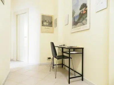 a table and a chair in a room at Re di Roma House in Rome