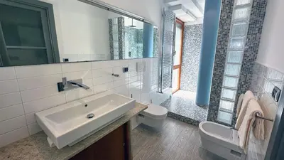 a bathroom with a sink and a toilet and a mirror at D10S SANPIETRO in Rome