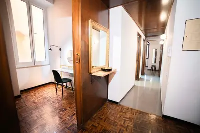 a hallway with a desk and a chair in a room at Fontana di Trevi sweet apartment in Rome