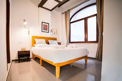 a bedroom with a large bed and a window at Fontana di Trevi sweet apartment in Rome