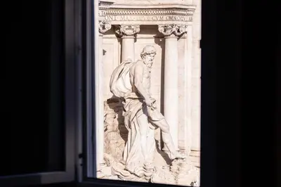 a statue on the side of a building at Fontana di Trevi sweet apartment in Rome