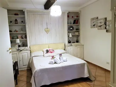 a bedroom with a bed with two dolls on it at Il Salotto di via Giulia in Rome