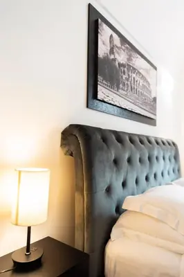 a bedroom with a bed and a picture on the wall at Colosseum superior suites in Rome