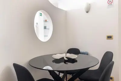 a group of cups hanging on a wall at Colosseum superior suites in Rome