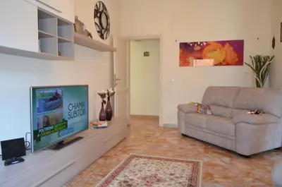 a living room with a couch and a flat screen tv at Holiday home Zia Gina in Rome