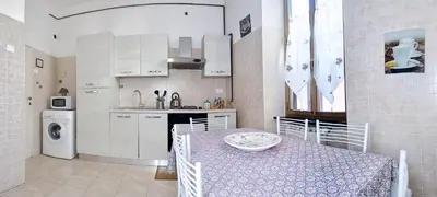 a kitchen with a table and a table and a dining room at Holiday home Zia Gina in Rome