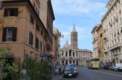 a busy city street with cars and a clock tower at Holiday home Zia Gina in Rome