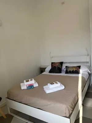 a bedroom with a bed with two towels on it at Renovated studio near the Vatican in Rome
