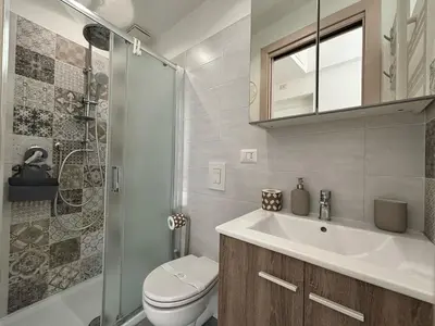 a bathroom with a sink and a toilet and a shower at Renovated studio near the Vatican in Rome