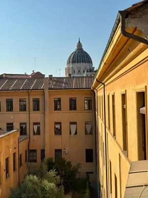 a view of a building with a dome in the background at Renovated studio near the Vatican in Rome