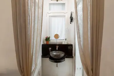 a bathroom with a sink and a window at Fiori Suite in Rome