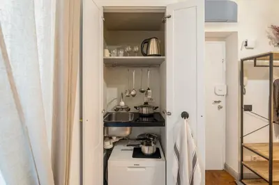 a small kitchen with a sink and a stove at Fiori Suite in Rome