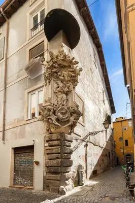 a clock on the side of a building at Fiori Suite in Rome
