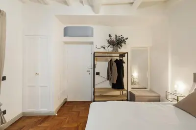 a white bedroom with a bed and a closet at Fiori Suite in Rome