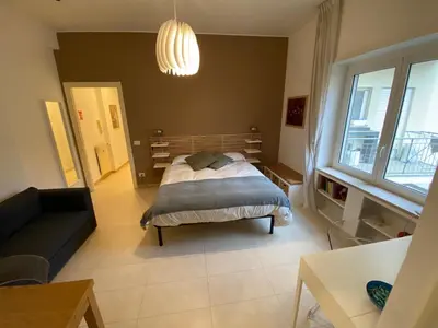 a bedroom with a bed and a couch at Houses Donatello & Tiziano Roma in Rome