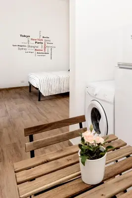 a laundry room with a bench and a washing machine at central comfortable studio apartment in Rome