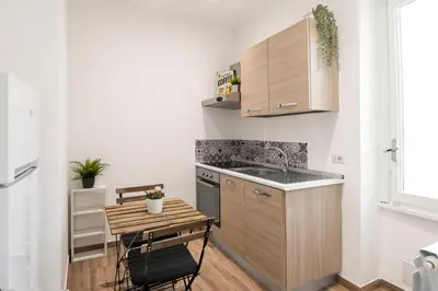 a small kitchen with a small table and a sink at central comfortable studio apartment in Rome