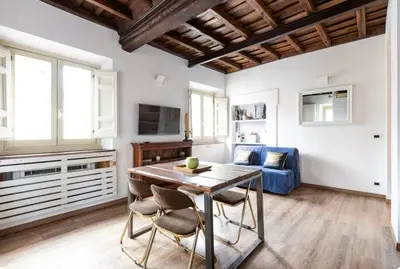 a living room with a table and a blue couch at Colosseo Luxury Suite in Rome
